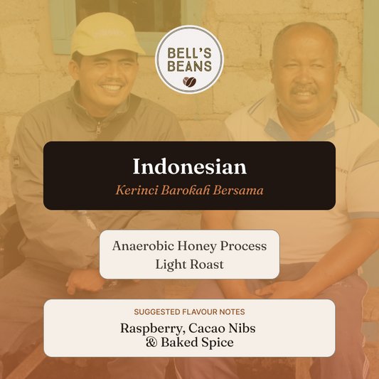 Two men sitting outdoors with a focus on Bell's Beans Indonesian coffee label.